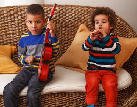Boys playing musical instruments Stock Photos