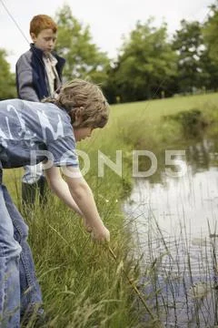 Boys Playing In Pond
