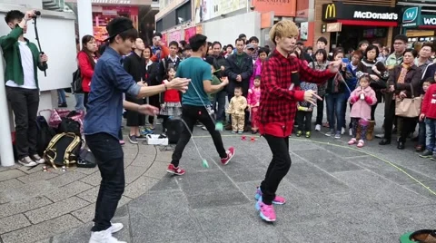Boys playing with a toy yo-yo on the waterfront of Hong Kong Stock Footage 48992115
