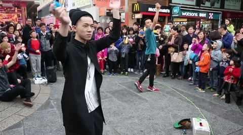 Boys playing with a toy yo-yo on the waterfront of Hong Kong Stock Footage 49017899