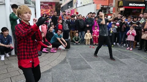 Boys playing with a toy yo-yo on the waterfront of Hong Kong Stock Footage 49017955