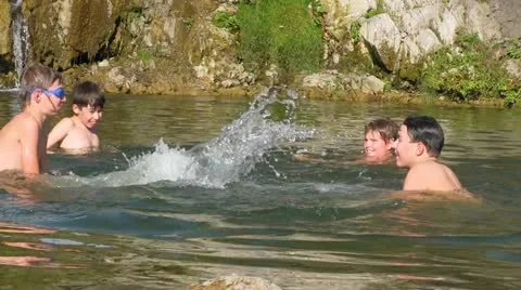 Boys playing in water Stock Footage 12097449