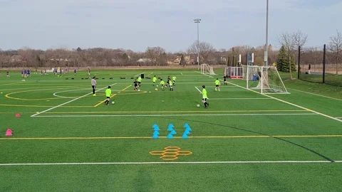 Boys practicing soccer on a multi-use ball field Stock Footage 151921411