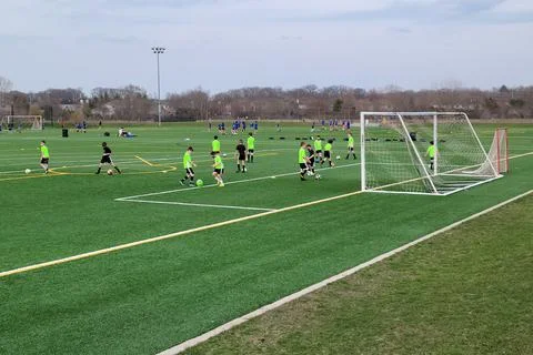 Boys practicing soccer on a multi-use ball field Foto stock