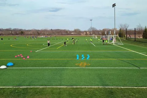 Boys practicing soccer on a multi-use ball field Stock Photos