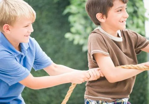 Boys pulling rope together Stock Photos