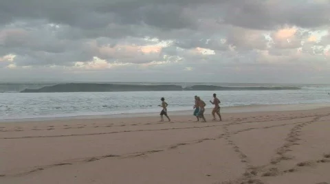 Boys running on beach Motion JPEG Stock Footage 800569