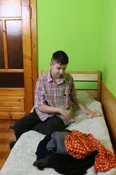 Boys sit at the kitchen table, talking and eating, enjoying tea and cozy home Stock Photos