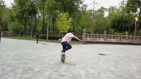 Boys skating in the park while doing tricks with the skateboard Stock Footage 148144887