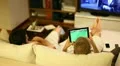 Boys on sofa watching tv and playing with tablet HD Footage