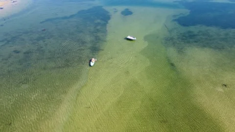 Boys on the Stand Up paddle in the lagoon Video stock 139355899