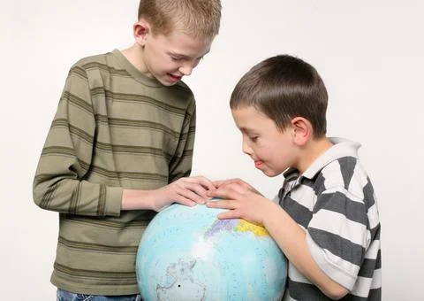 Boys studying globe Stock Photos