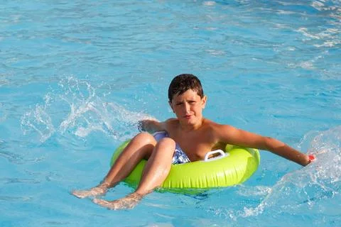 Boys swimsuit floating in the pool float Boys, teenager swimsuit floating ... Stock Photos