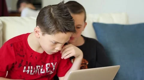 Boys take turns using laptop computer Video stock 40712219
