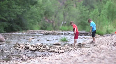 Boys throwing rocks in river 02 Video stock 43386511