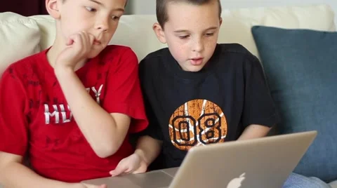 Boys using laptop computer taking turns Video stock 40712312