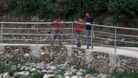 Boys Walking along Railing Stock Footage 111035020