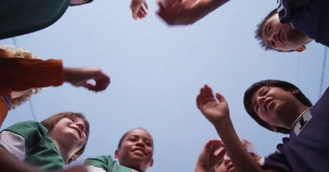 Boy's youth soccer team huddle and stack hands. Stock Footage