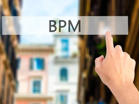 BPM (Business Process Management) - Hand pressing a button on blurred backgro Stock Photos