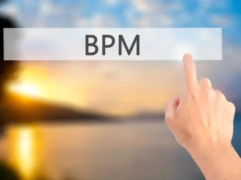 BPM (Business Process Management) - Hand pressing a button on blurred backgro Stock Photos