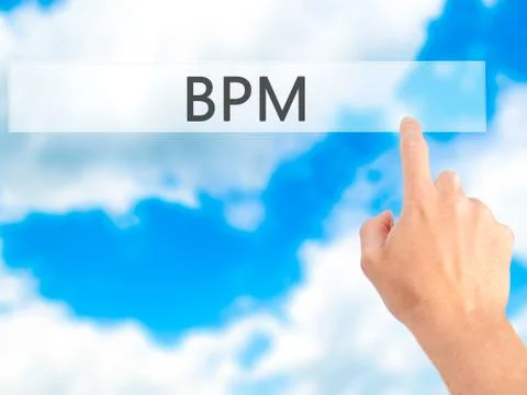 BPM (Business Process Management) - Hand pressing a button on blurred backgro Stockfoto's