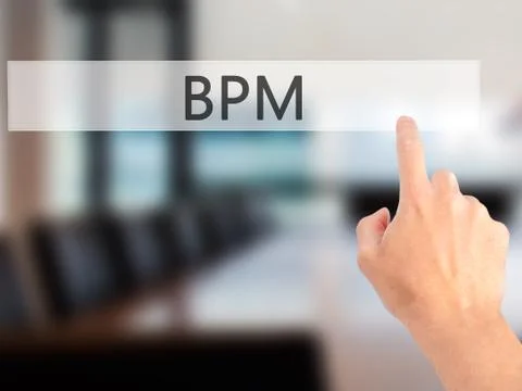 BPM (Business Process Management) - Hand pressing a button on blurred backgro Stock Photos