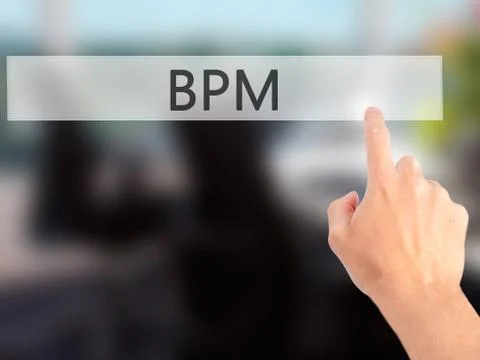 BPM (Business Process Management) - Hand pressing a button on blurred backgro Stockfoto's