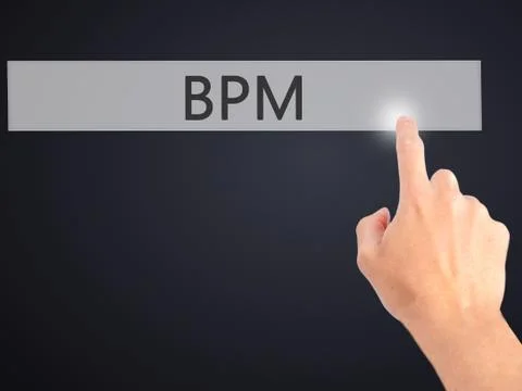 BPM (Business Process Management) - Hand pressing a button on blurred backgro Stockfoto's