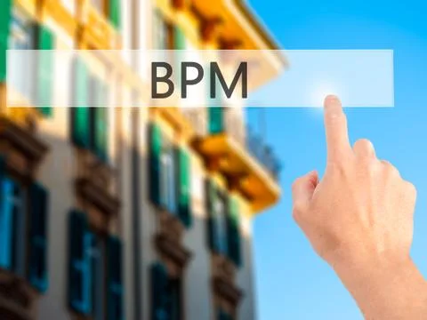BPM (Business Process Management) - Hand pressing a button on blurred backgro Stock Photos