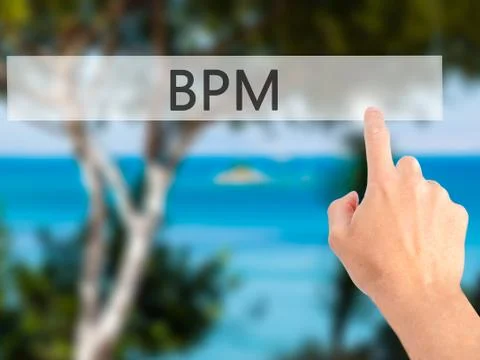 BPM (Business Process Management) - Hand pressing a button on blurred backgro Stockfoto's