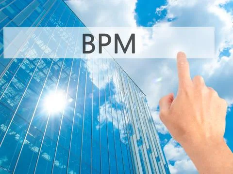 BPM (Business Process Management) - Hand pressing a button on blurred backgro Stockfoto's