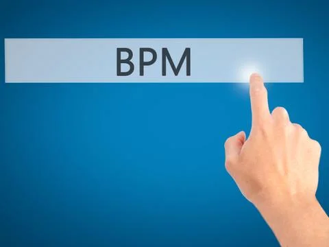 BPM (Business Process Management) - Hand pressing a button on blurred backgro Stockfoto's