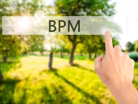 BPM (Business Process Management) - Hand pressing a button on blurred backgro 库存照片