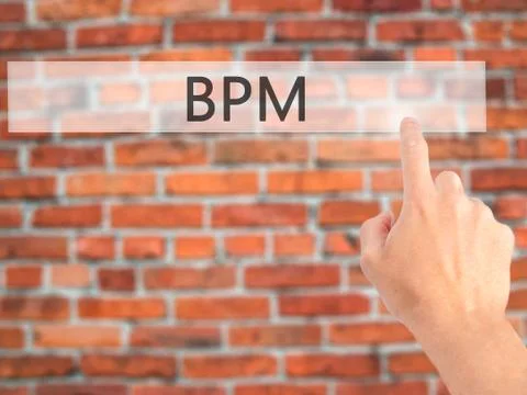 BPM (Business Process Management) - Hand pressing a button on blurred backgro 库存照片
