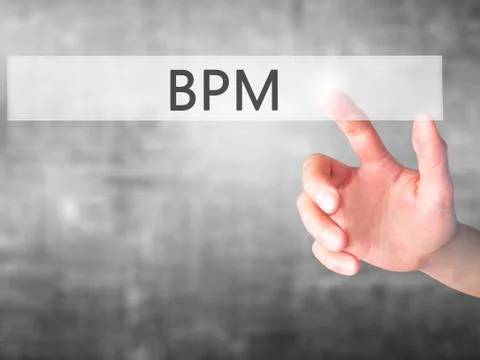 BPM (Business Process Management) - Hand pressing a button on blurred backgro Stockfoto's