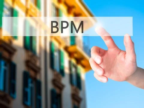 BPM (Business Process Management) - Hand pressing a button on blurred backgro 库存照片