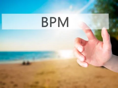 BPM (Business Process Management) - Hand pressing a button on blurred backgro Stockfoto's