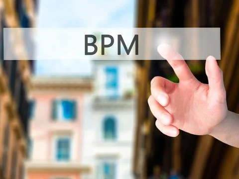 BPM (Business Process Management) - Hand pressing a button on blurred backgro Stock Photos