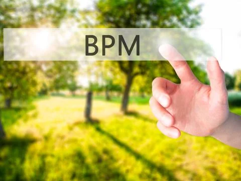 BPM (Business Process Management) - Hand pressing a button on blurred backgro Stockfoto's