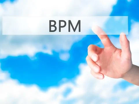BPM (Business Process Management) - Hand pressing a button on blurred backgro 库存照片