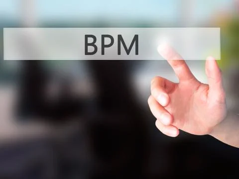 BPM (Business Process Management) - Hand pressing a button on blurred backgro 库存照片