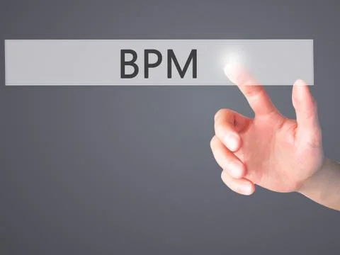 BPM (Business Process Management) - Hand pressing a button on blurred backgro Stockfoto's