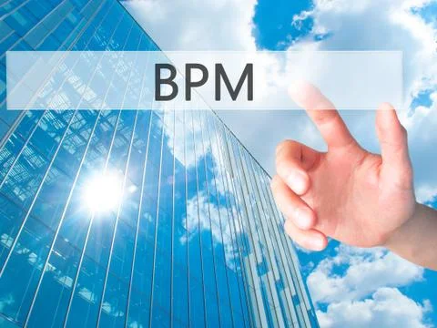 BPM (Business Process Management) - Hand pressing a button on blurred backgro Stockfoto's