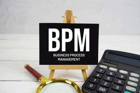 BPM Business Process Management text with magnifying glass and calculator o.. Stock Photos