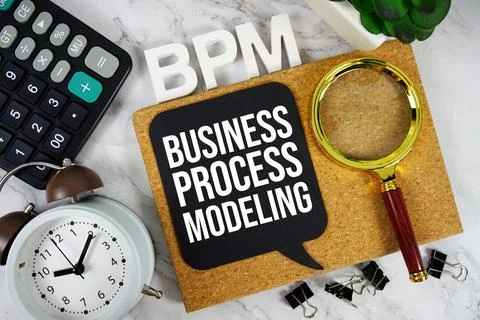 BPM Business Process Modeling acronym with calculator, alarm clock and magn.. Stock Photos