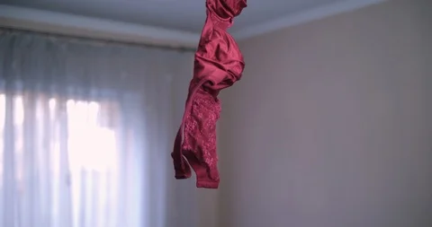 Bra hanging on a chandelier on the ceiling Stock Footage 88730835