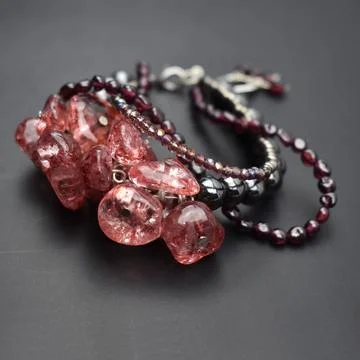 Bracelet made of natural red ruby on a black background. Stock Photos