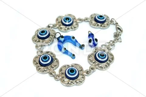 Bracelet,horse-shoe and drop medallions Stock Photos