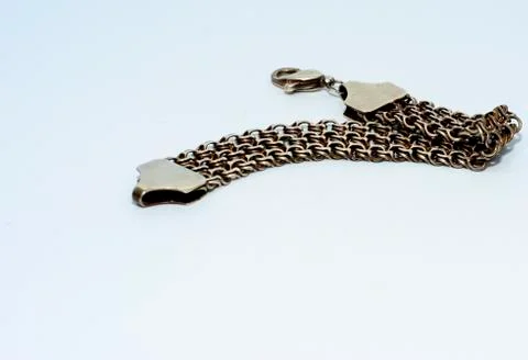 Bracelets, chains and crosses of silver on a white background Stock Photos