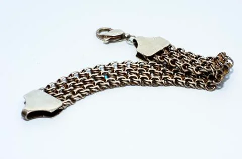 Bracelets, chains and crosses of silver on a white background Stock Photos